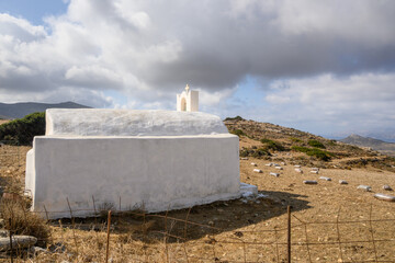 White Greek chapel, rural landscape in the northern part of the island of Ios. Cycades Islands....