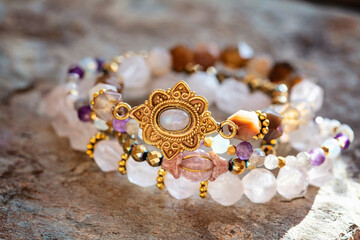 Collection of natural mineral gemstone beads bracletes on natural neutral background