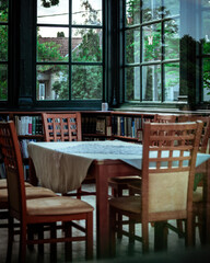 Old library reading room from outside through the window with some reflection.
