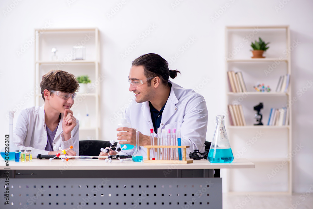 Wall mural Young father and son chemists in the lab