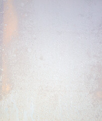 Drops of water on glass in the rays of the dawn of the sun.