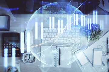 Multi exposure of forex graph drawing over desktop background with computer. Concept of financial analysis. Top view.