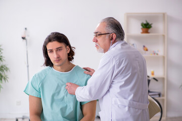 Fototapeta premium Young male patient visiting experienced doctor
