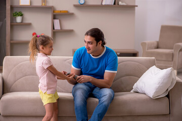 Young man with his daughter at home