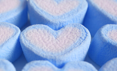 Obraz na płótnie Canvas Closeup Pastel Blue and White Heart Shaped Marshmallow Candies in Rows