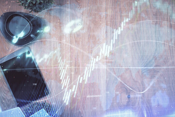 Multi exposure of financial chart hologram over desktop with phone. Top view. Mobile trade platform concept.