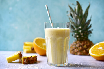 Tropical smoothie with pineapple, banana, coconut and orange.