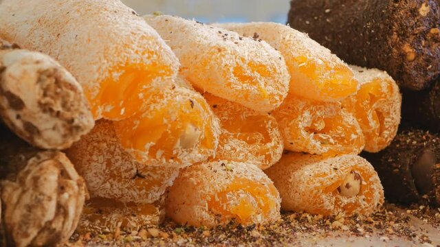 Fresh Turkish delight with apricots and chocolate sprinkled with coconut chips. Ramadan. Oriental sweets at the spice market in Istanbul. Dolly shooting. Close-up