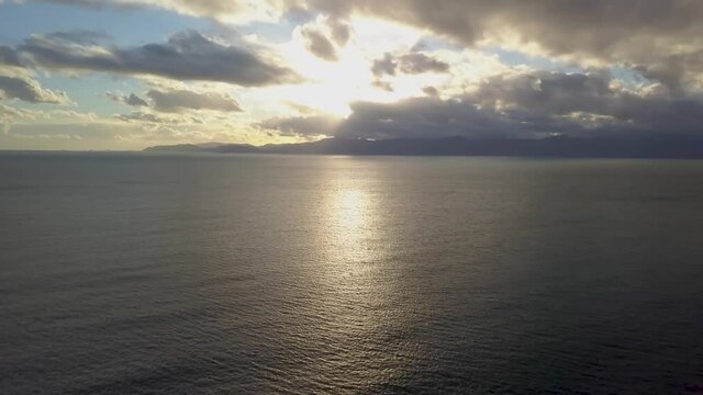 horizon on the shoreline of cagliari (calamosca) at sunset with clouds and calm sea during winter season.