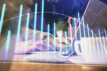 Double exposure of woman hands typing on computer and forex chart hologram drawing. Stock market invest concept.