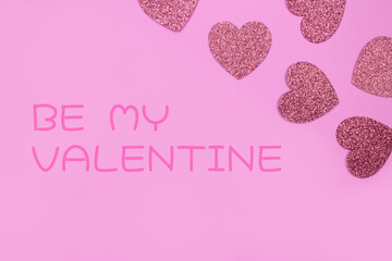 Be my Valentine greeting card with pink glitter hearts on pink background - St. Valentine's Day celebration concept. Love backdrop for greeting card, copy space for your text, selective focus