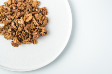Peeled walnuts on a white background. The view from the top. The concept of healthy eating.