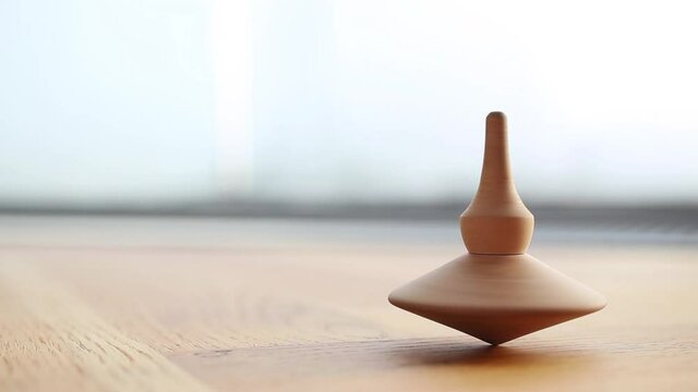 Wooden Totem spinning top coming to an end
