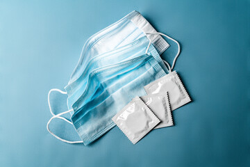 Condom and medical surgical mask. Concept safe sex during quarantine, covid-19