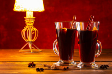 Mulled wine on rustic wooden table. Romantic evening for two.