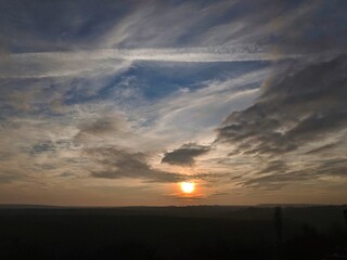 Obraz premium The magnifique nature high-view. Outside. Beautiful land view on the horizon. Skyline. Magnific sunset on the nature outdoor. Sunlight, sun rays on the Earth. The horizon line between sky and ground. 