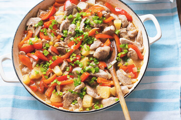 Sweet and sour Chinese chicken with pineapple, red pepper, chives