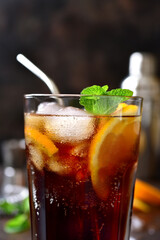 Cold summer soda cocktail with cola, dark rum and orange.