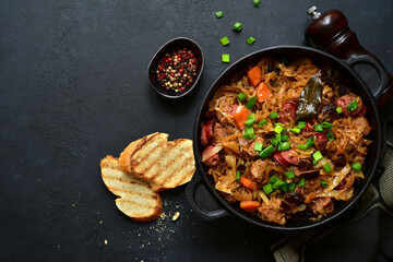 Bigos - traditional dish of polish cuisine,stewed cabbage with meat, sausage and dried mushrooms. Top view with copy space.