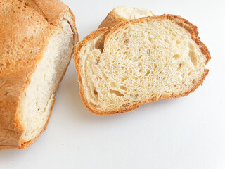 loaf of bread. Closeup freshly baked homemade traditional bread on white background. Concept - Cooking at Home. Sliced bread 