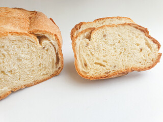 loaf of bread.  Closeup freshly baked homemade traditional bread on white background. Concept - Cooking at Home. Sliced fresh bread 