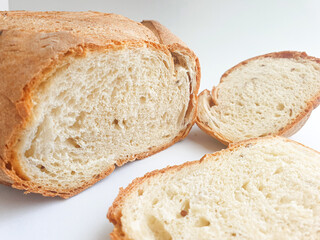 loaf of bread. Sliced fresh bread. Closeup freshly baked homemade traditional bread on white background. Concept - Cooking at Home