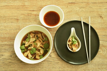 stewed duck intestine in brown soy soup on bowl dipping with spicy chili sauce