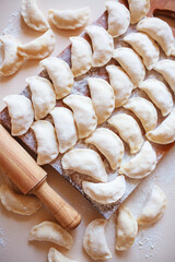 Ukrainian traditional dumplings on a wooden board.