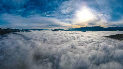 mountains tops high above clouds fog