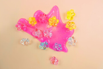 Pink neon slime and glass flowers decorative elements.  Liquid art gel background. Abstract...