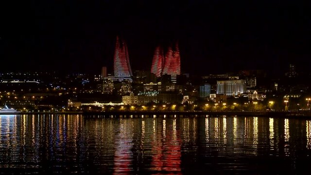 Baku, Azerbaijan - July 2019: Night view of Baku with the Flame Towers skyscrapers, television tower and the seaside of the Caspian sea