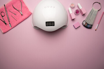 Set of manicure tools and accessories on a pink background. Hardware manicure,Flat lay.
