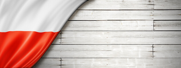 Polish flag on old white wall banner
