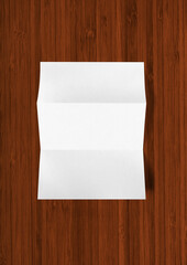 Blank folded White A4 paper sheet mockup template on dark wooden background