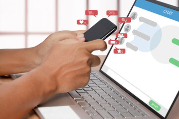 Social media on smartphone with notification icon and computer laptop.