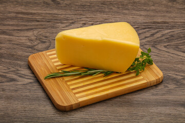 Hard cheese piece served rosemary