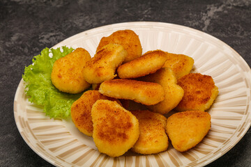 Fried chicken nuggets served salad leaves