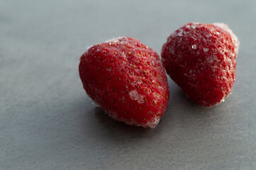 Frozen strawberries on a gray background