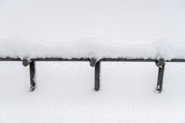 fence under the snow in winter