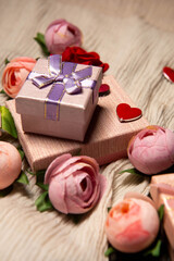 There are gift boxes next to the flowers on the table. Red heart symbol of love. Gifts for the holiday. Gifts for Valentine's Day. International Women's Day. Decoration.