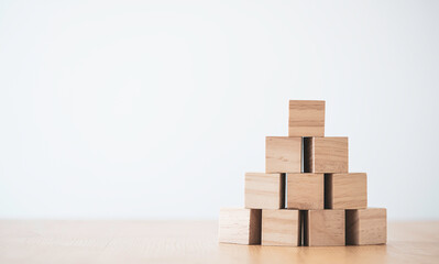 Stacking blank wooden cubes on table with copy space for input wording and infographic icon.