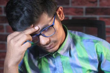 Young man suffering headache, close up 