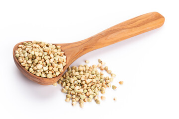 Raw buckwheat and wooden spoon on white background.