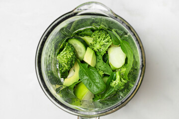 Blender with vegetables and fruits for cooking healthy detox green smoothie. Top view