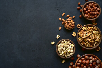 Variety of nuts in a wooden bowl . Top view with copy space.