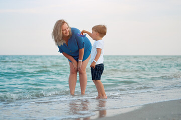 Mother son spending time together sea vacation Young mom child little boy walking beach