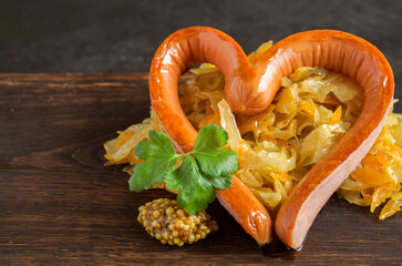 braised pickled cabbage with grilled sausage in the shape of a heart.