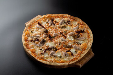 Plain chicken and mushroom pizza with melted cheddar cheese on a thin dough, light dietary pizza