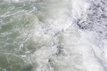 Fototapeta na wymiar Big waves at open sea. Summer monsoon. White crest of a sea wave. texture background