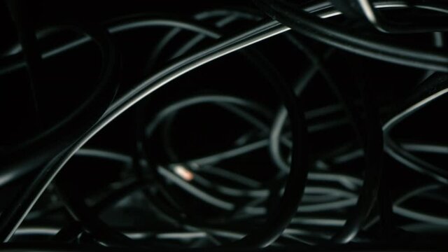 Tangled data cable or electrical cable close up.
